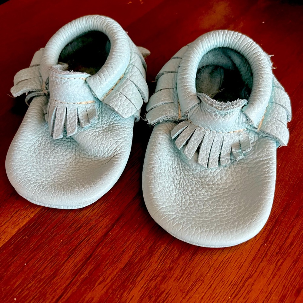 Lightly used freshly picked baby moccasins size 4